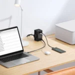 Baseus GaN5 Pro 65W Digital Power Strip charging laptop and earbuds on office desk